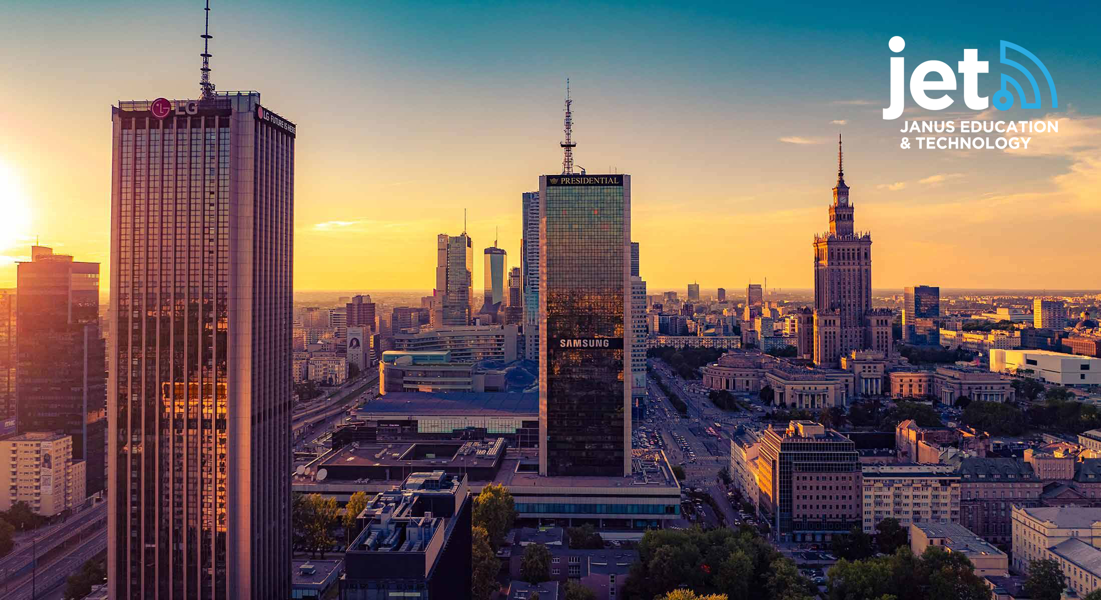 A panoramic view of Warsaw's city center at sunset, featuring modern skyscrapers and the iconic Palace of Culture and Science, with the Janus Education & Technology (JET) logo in the top right corner.